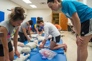 Students participate in a CPR class